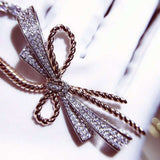 Two-color bow necklace